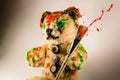 Bear toy as an artist holding a paintbrush