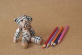 Bear toys on texture of paper backgrounds and pencils Royalty Free Stock Photo