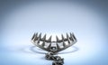 Bear trap waiting for prey on blue background Royalty Free Stock Photo