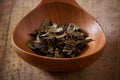 Bearberry leaves in a wooden spoon