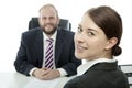 Beard business man brunette woman at desk smiling