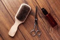 Beard grooming accessories on a luxury wooden surface.