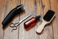 Beard grooming accessories on a luxury wooden surface.