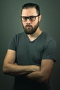 Beard hipster with eye glasses, arm crossed looking seriously at camera Royalty Free Stock Photo