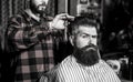 Beard man in barbershop. Hairstylist serving client at barber shop, bearded. Hairdresser, bearded man. Vintage Royalty Free Stock Photo