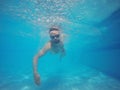 Beard man with glasses swimming under water in the pool Royalty Free Stock Photo