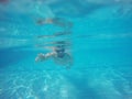 Beard man with glasses swimming under water in the pool Royalty Free Stock Photo