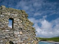 With beard moss lichen, the gable end wall at St Olaf`s Church at Lunda Wick, Unst, Shetland, UK