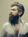 Beard and mustache care product. Man brutal bearded hipster strict face close up. Growing epic beard also means growing