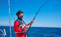 Beard sailor man fishing rod trolling in saltwater Royalty Free Stock Photo