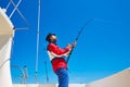 Beard sailor man fishing rod trolling in saltwater Royalty Free Stock Photo