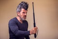 Bearded angry man with tonfa. People, emotions concept Royalty Free Stock Photo