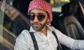 Bearded arab businessman wearing traditional Keffiyeh head scarf looking out of car window Royalty Free Stock Photo