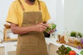 Bearded Asian man in overalls standing in the kitchen He is using his hand to peel a mango that is ready to eat. to prepare for Royalty Free Stock Photo