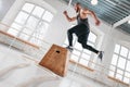 Bearded athlete male jumping over wooden box in sport gym Royalty Free Stock Photo