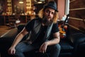 Bearded barber sitting on black leather couch