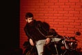 Bearded biker. bearded biker sitting on motorbikie. bearded biker in leather jacket. bearded biker in repair shop, copy