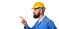 Bearded builder in hard hat, foreman or repairman in the yellow helmet pointing his finger in profile Portrait architect builder