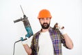 Bearded builder working with hammer and drill. Builder with professional tools Royalty Free Stock Photo