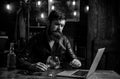 Bearded business man with glass of whiskey. Stressed from hard work. Royalty Free Stock Photo