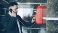 Bearded businessman dial red telephone talking with staff at reception in hotel lobby. Business, travel and people Royalty Free Stock Photo