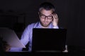 Bearded businessman is doing paper work in front of laptop Royalty Free Stock Photo