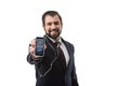 Bearded businessman with earphones showing smartphone with tumblr website