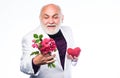 Bearded businessman. heart failure. happy mature man hold flowers and heart. love and romance. anniversary and