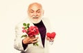 bearded businessman. heart failure. happy mature man hold flowers and heart. love and romance. anniversary and