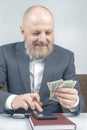 Bearded businessman offers payment for work with money. concept of value of time to pay for busines