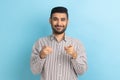 Bearded businessman pointing fingers at camera and looking with toothy smile, believes in you. Royalty Free Stock Photo