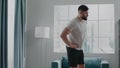 Bearded businessman practices active athletic bends warmup