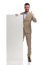 Bearded businessman presenting empty board and making thumbs up gesture Royalty Free Stock Photo