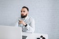 Bearded businessman sitting at a desk in the office Royalty Free Stock Photo