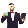 Bearded businessman or speaker with concentrated look, planner and cup
