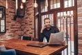 Bearded businessman  talking on a mobile phone while reading newspapers Royalty Free Stock Photo