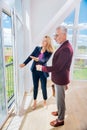 Bearded businessman wearing grey trousers standing in his new future house