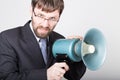 Bearded businessman yelling through bullhorn. Public Relations. man expresses various emotions. photos of young Royalty Free Stock Photo