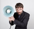 Bearded businessman yelling through bullhorn. Public Relations. man expresses various emotions. photos of young Royalty Free Stock Photo