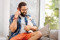 Bearded caring owner of dog looking at him speaking on phone