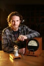Bearded Caucasian electric man posing with a vintage voltmeter and a light bulb Royalty Free Stock Photo