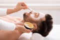 Bearded caucasian man getting face treatment at spa salon Royalty Free Stock Photo