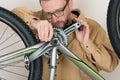 Bearded caucasian man repairing the mtb bicycle