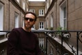 Bearded Caucasian man with sunglasses posing in the balcony Royalty Free Stock Photo