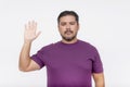 A bearded chubby man makes a solemn oath. Wearing a purple waffle shirt. Half body photo isolated on white background