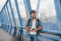 Bearded cyclist using phone while waiting for bus. Royalty Free Stock Photo