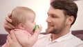 Bearded daddy kissing baby infant. Father kissing baby. Happy man with baby