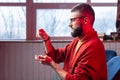 Bearded diviner wearing glasses and bracelet reading oracle cards Royalty Free Stock Photo