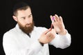 Bearded doctor holding test tube.