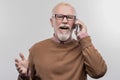 Bearded elderly man feeling excited while calling his loving caring wife Royalty Free Stock Photo